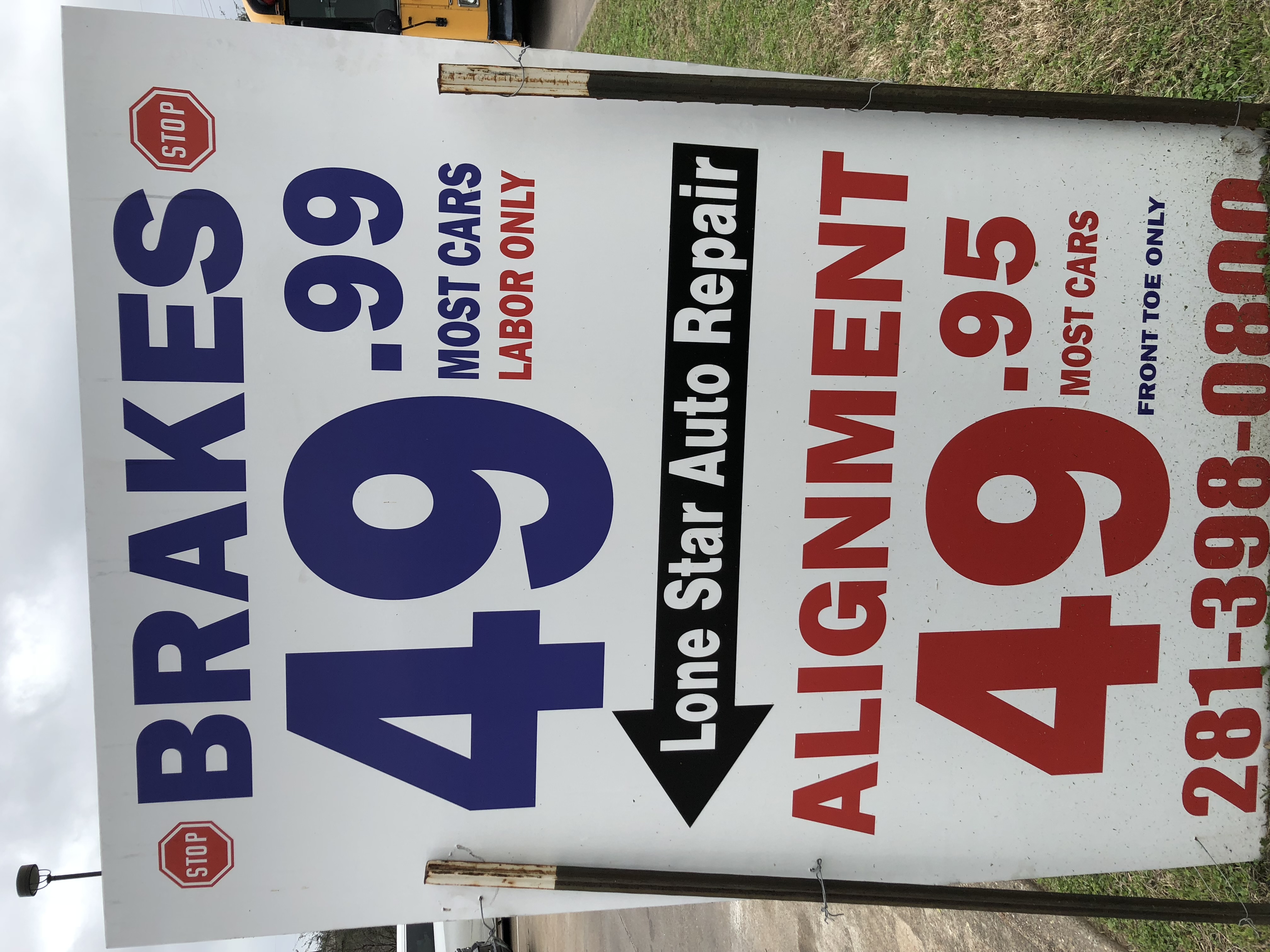 Lonestar Auto Repair pricing sign showing brake and alignment specials